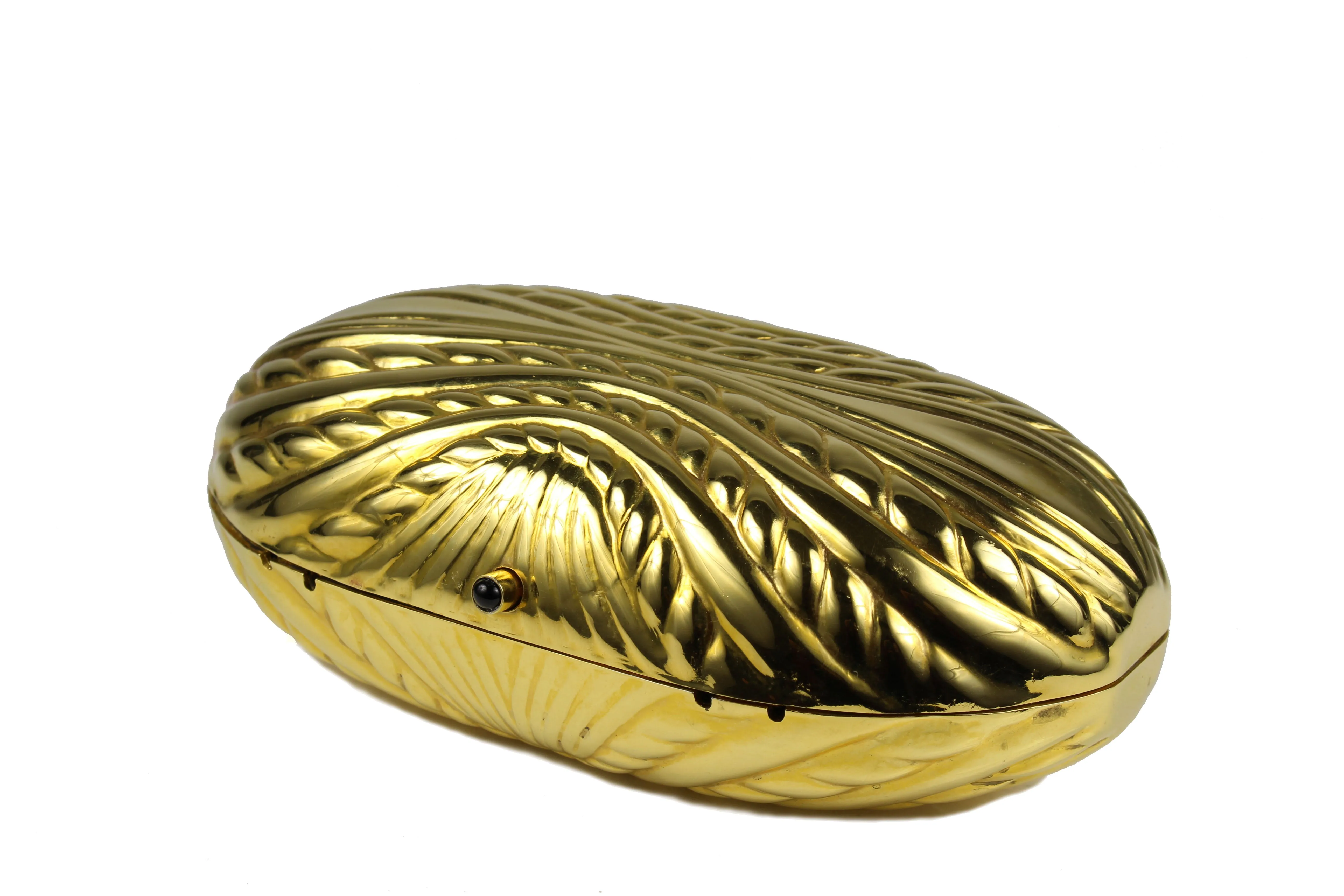 Golden metal oval-shaped clutch